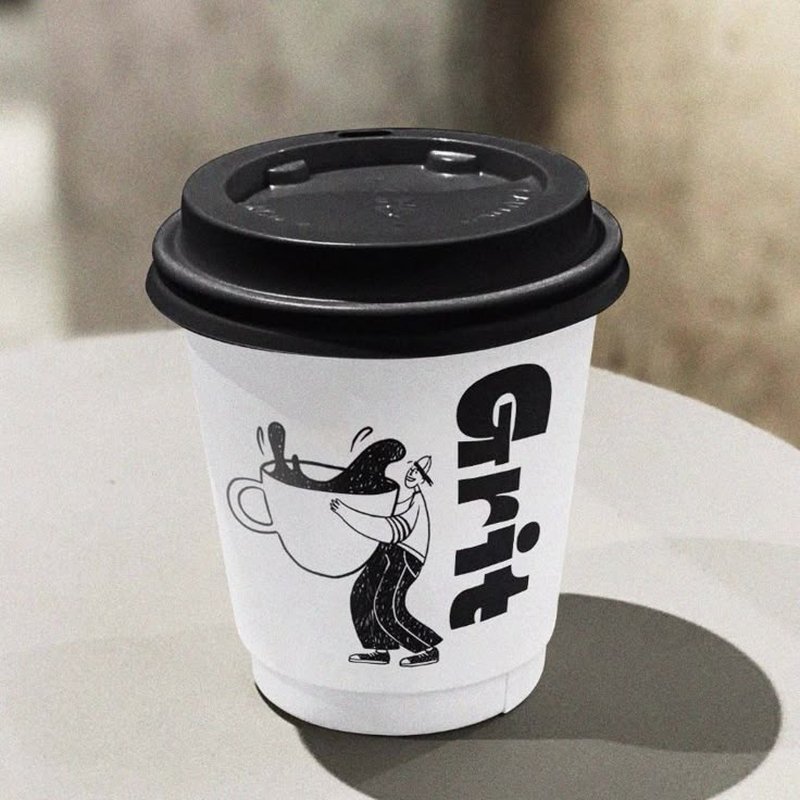 A custom-printed coffee cup on a café table